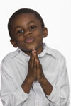 image of smiling young boy praying