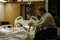 image of man praying for sick patient